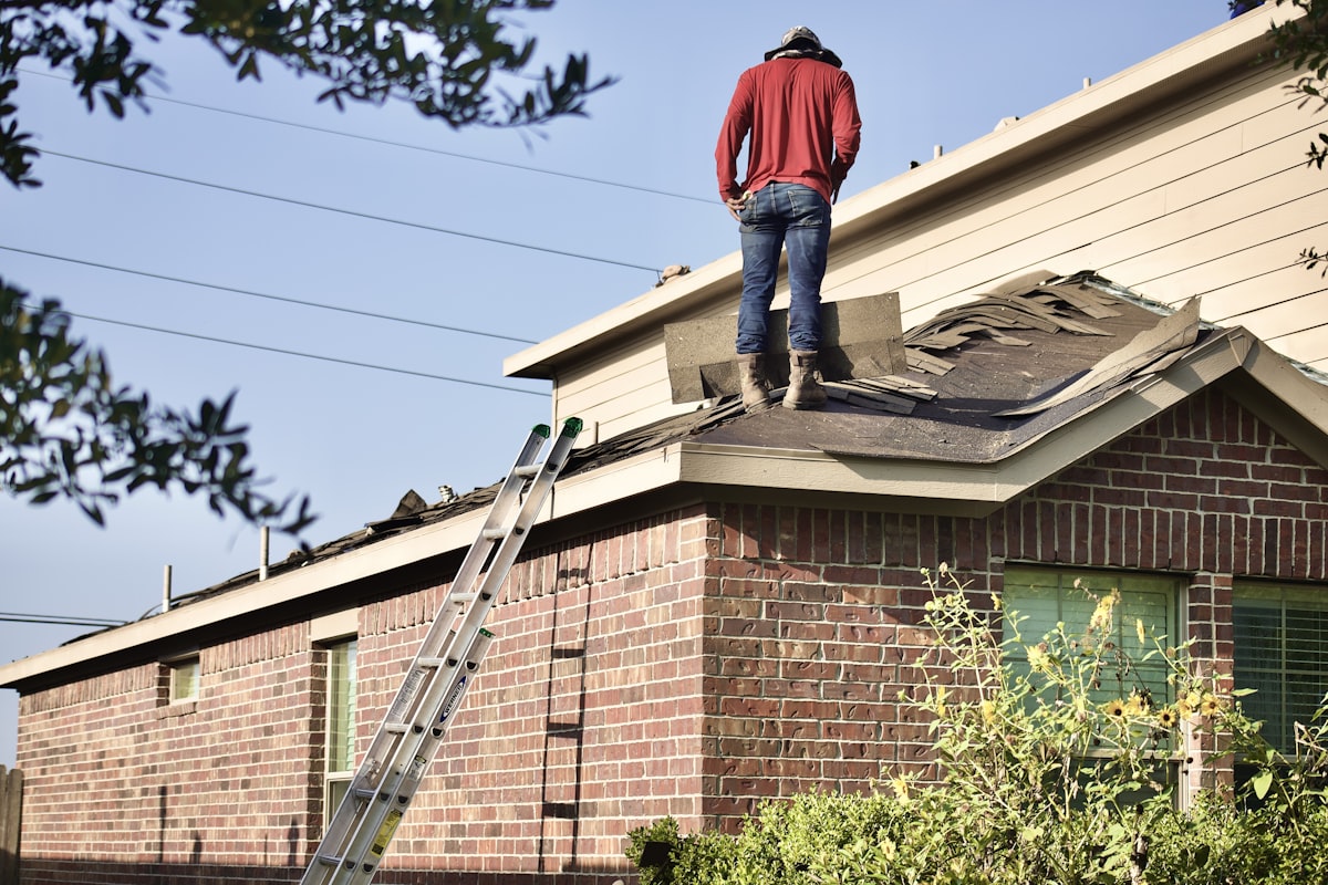 Emergency roofer on ladder